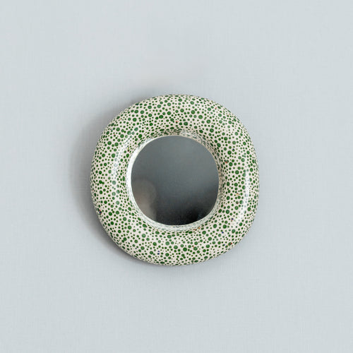 Round ceramic wall mirror with green dots pattern 