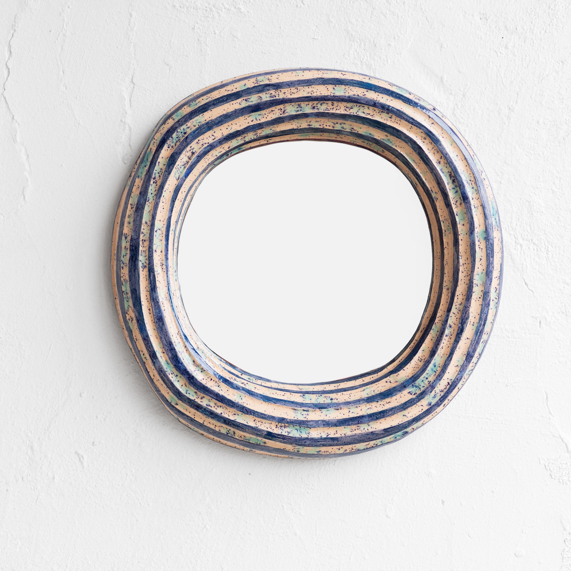 Round mirror with a decorative blue frame 