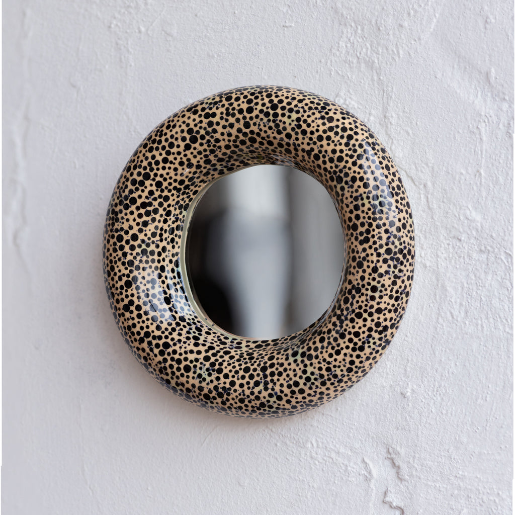 Round mirror with a spotted frame